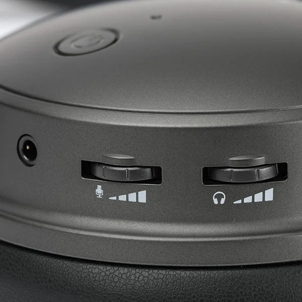 Close-up of Audeze Maxwell ear cup controls showing dual volume sliders, power button, and 3.5mm jack