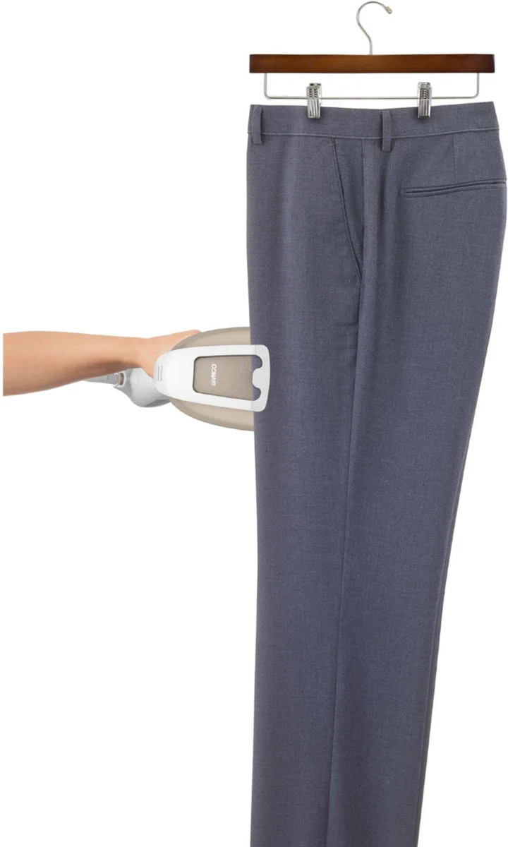 Conair Turbo ExtremeSteam GS59X in use, steaming wrinkles from hanging trousers on a clothes hanger