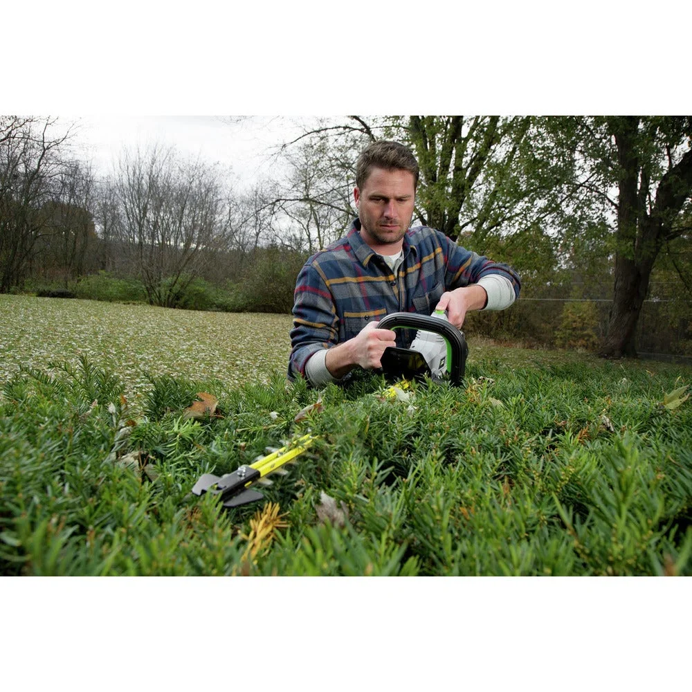 Man trimming the top of a low hedge with EGO Power+ HT2411 in outdoor garden setting
