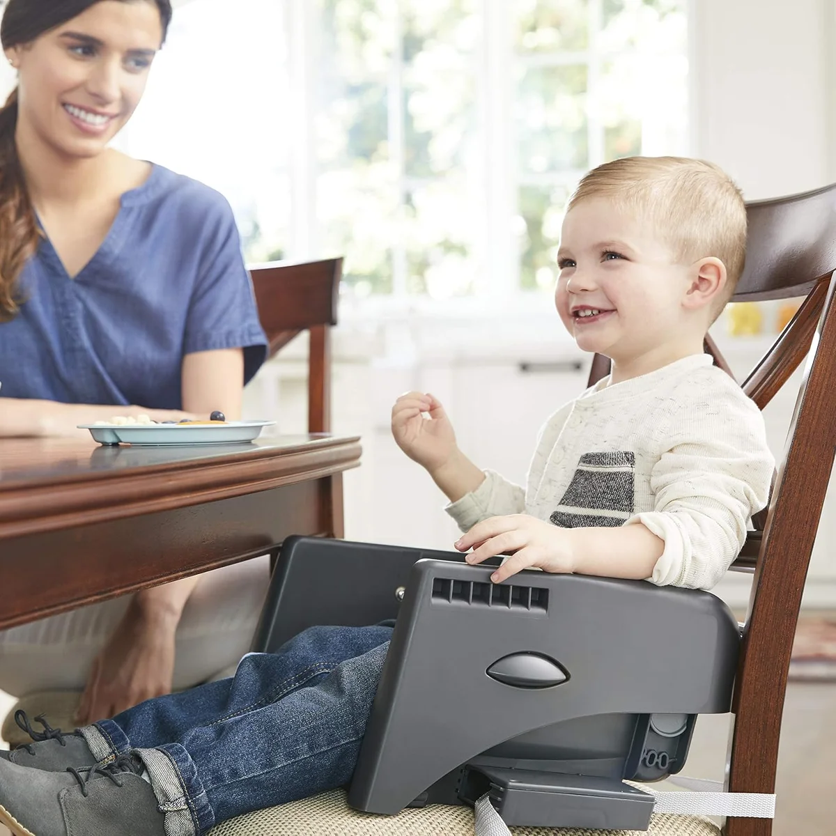 Toddler using Graco DuoDiner DLX as a youth booster seat at the dining table