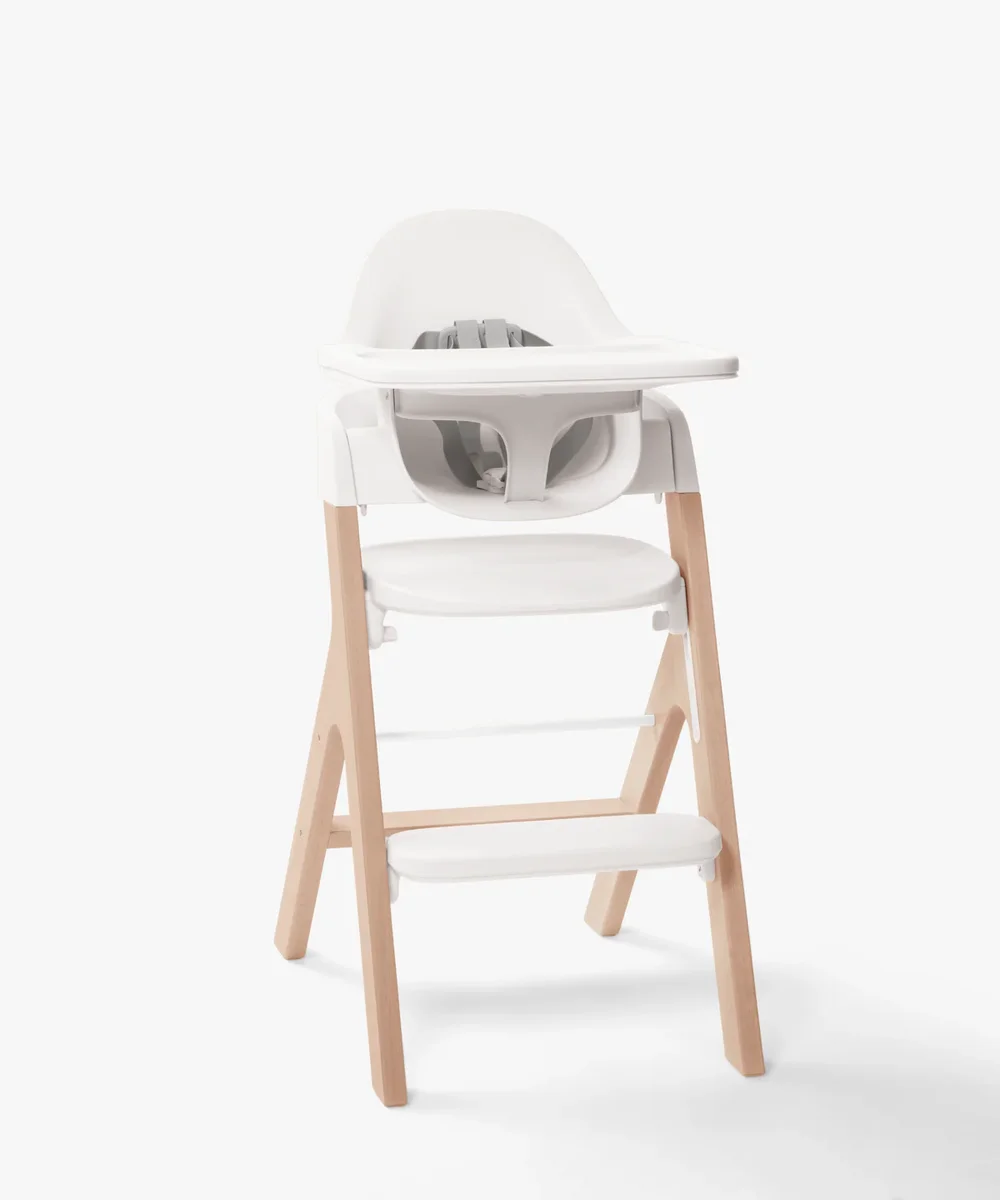 Mockingbird High Chair in Natural finish with beechwood legs and white shell, 3/4 view