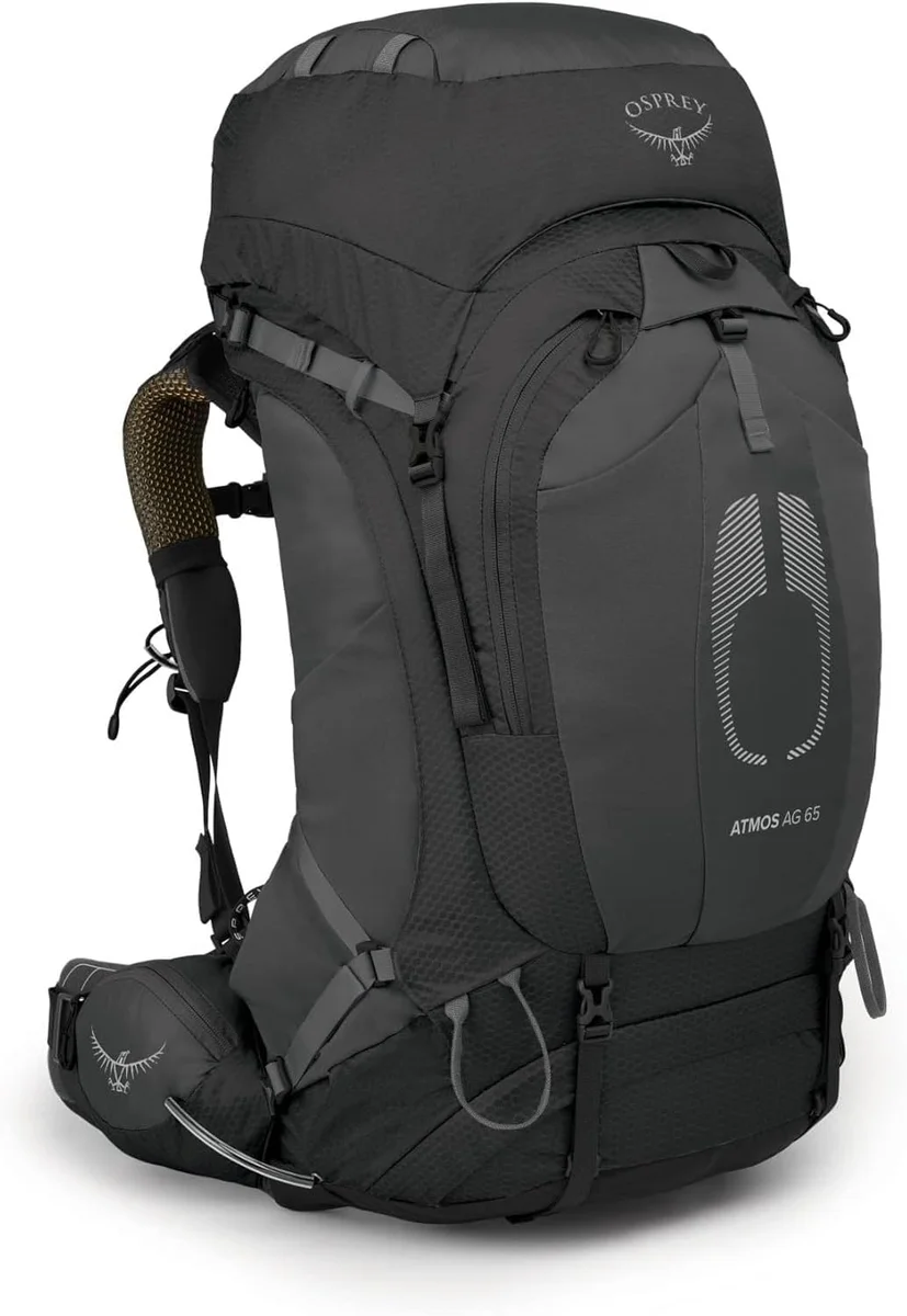 Osprey Atmos AG 65 side-angle view showing J-zip side access, compression straps, and hip belt pocket