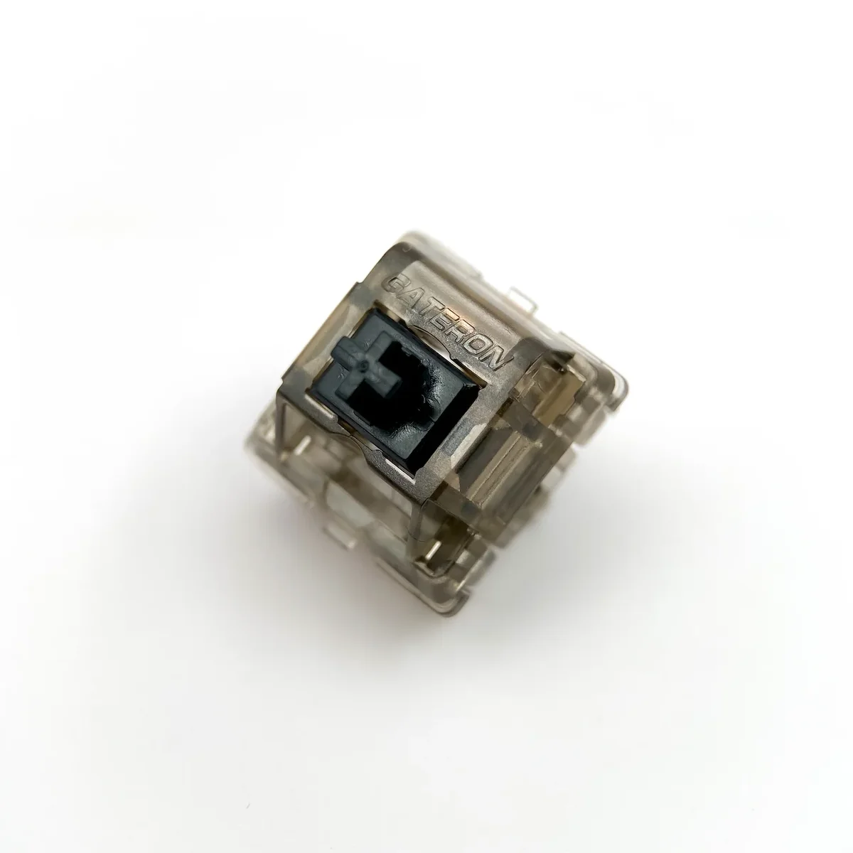 Gateron Ink Black V2 switch overhead angle showing Gateron branding on smoky housing