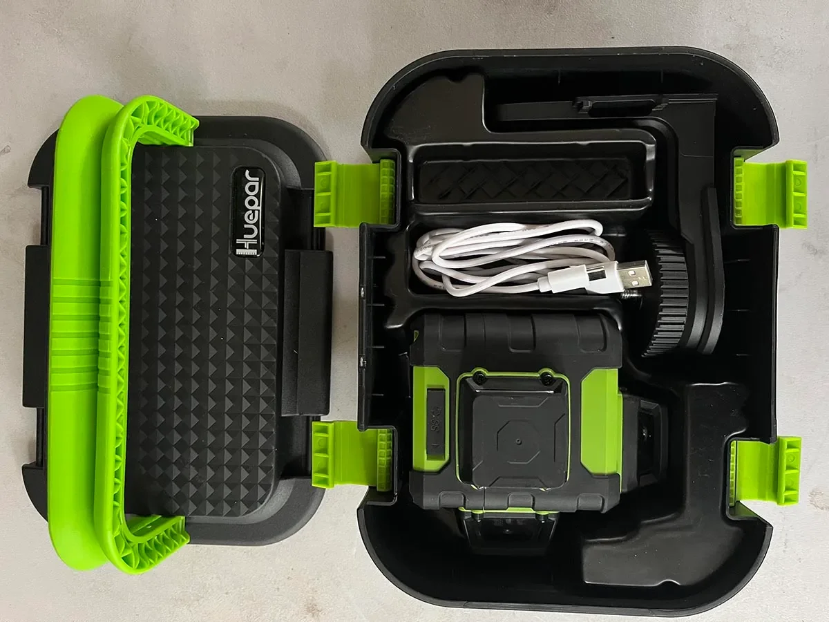 Huepar HM03CG stored inside its hard carry case with USB-C charging cable