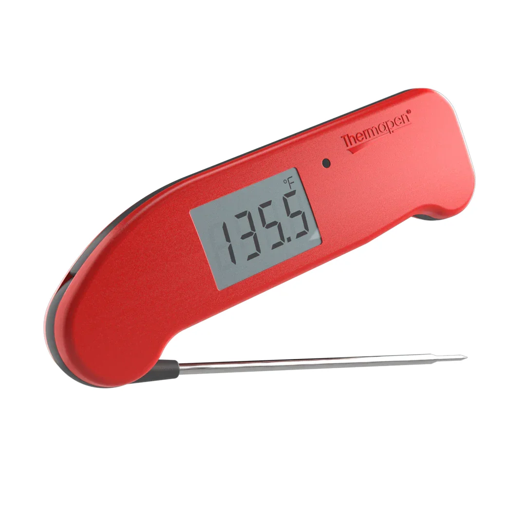 ThermoWorks Thermapen ONE instant-read thermometer in red with probe extended, showing 135.5 degrees F on the display