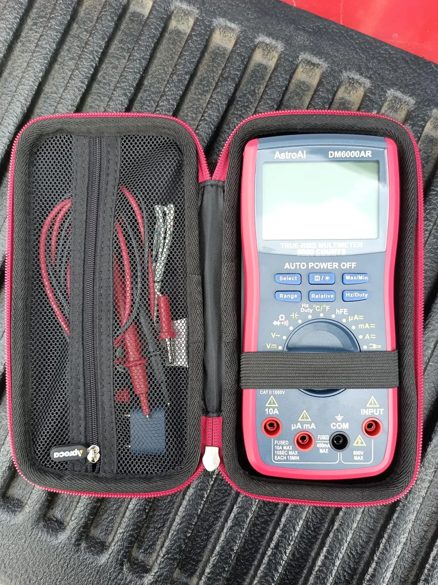 AstroAI DM6000AR multimeter secured in its zippered hard carry case with test leads stored in the mesh pocket
