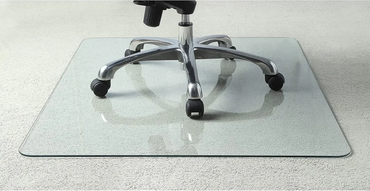 Lorell Tempered Glass Chair Mat under an office chair on carpet