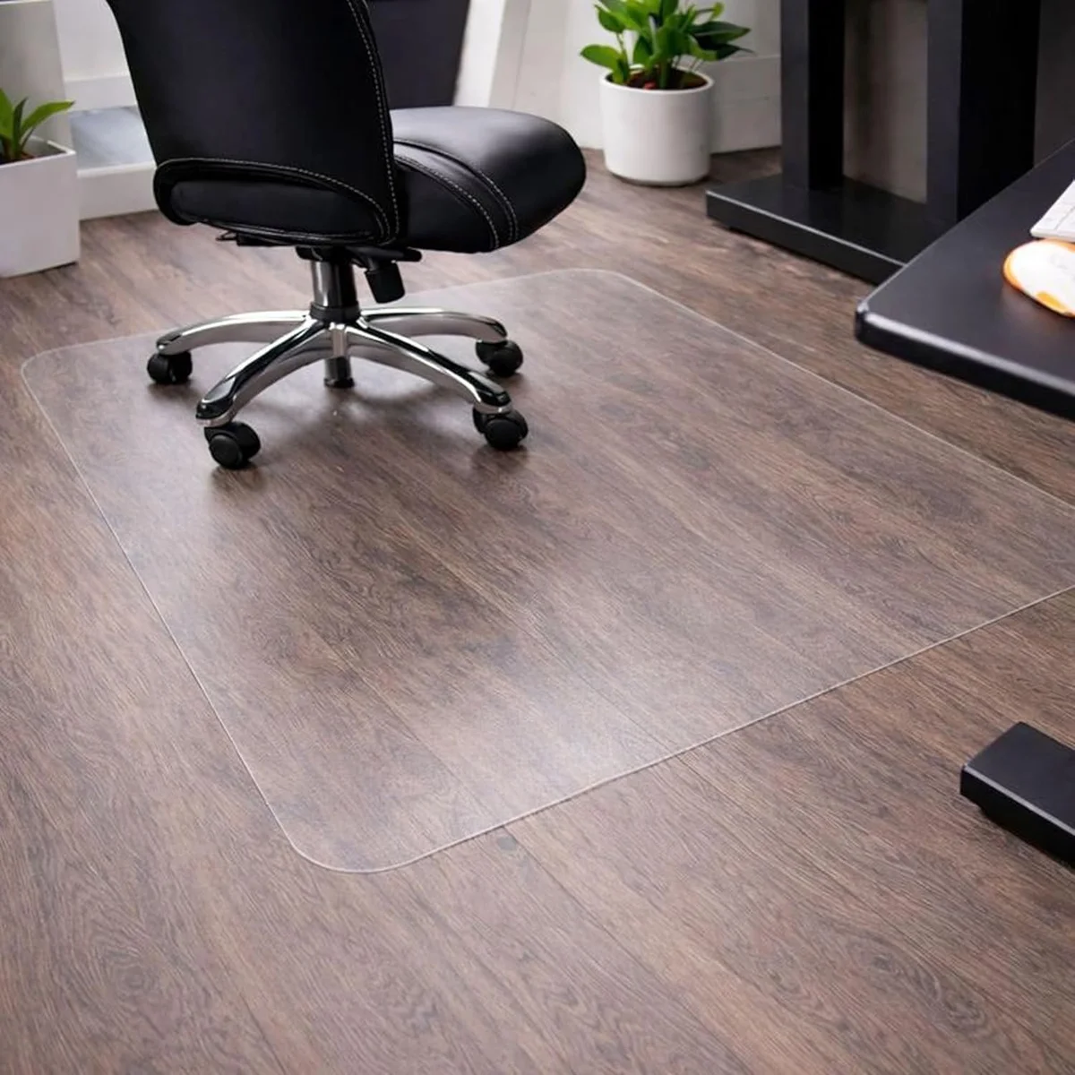 Marvelux polycarbonate office chair mat under a rolling office chair on hardwood flooring