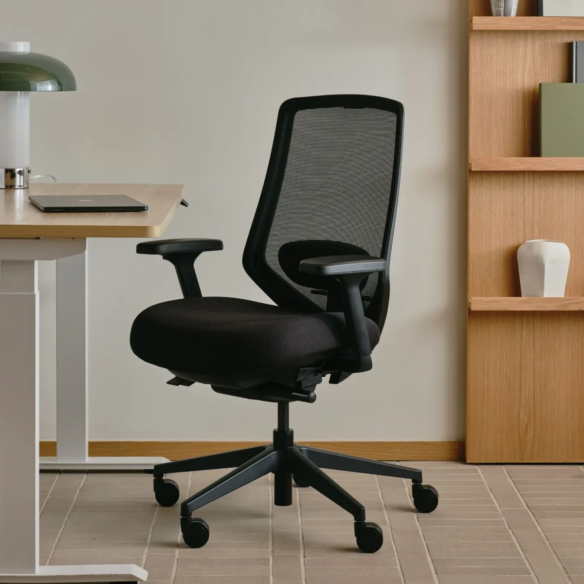 Branch Ergonomic Chair Pro in black mesh at a standing desk in a home office