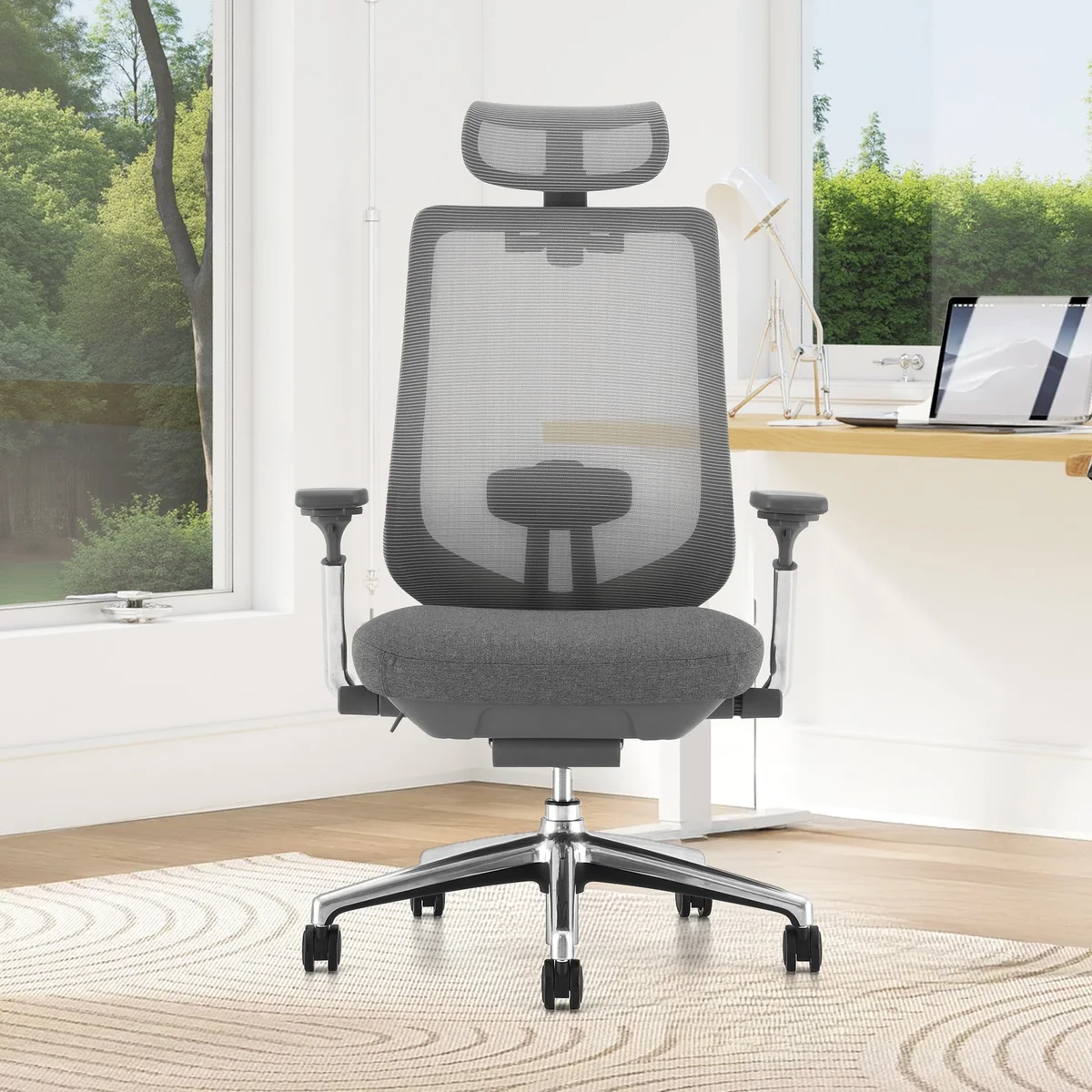 Colamy Atlas at a home office desk with laptop, showing full chair profile in natural light