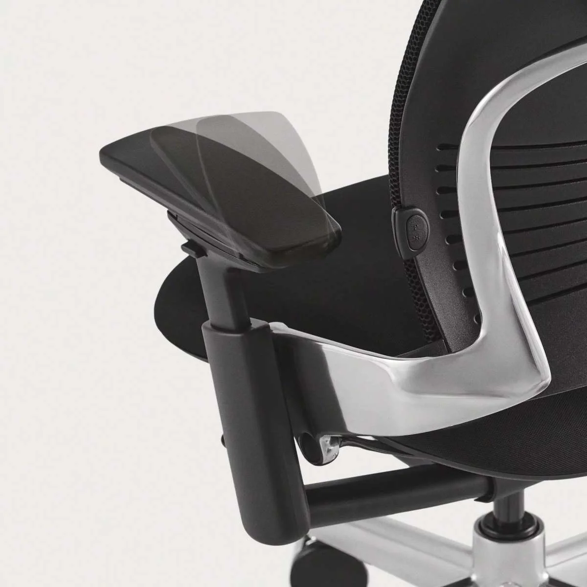 Steelcase Leap 4D armrest close-up showing height and pivot adjustment range