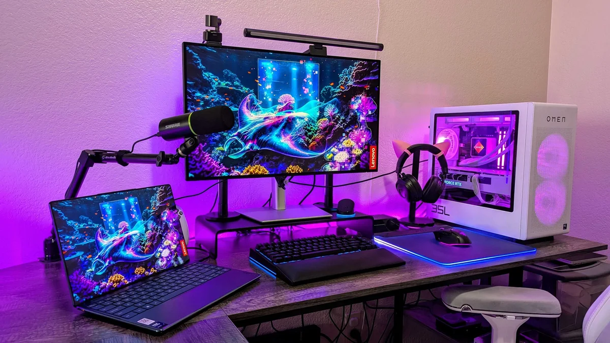 Dell U2725QE in a desk setup alongside a laptop, keyboard, and PC tower