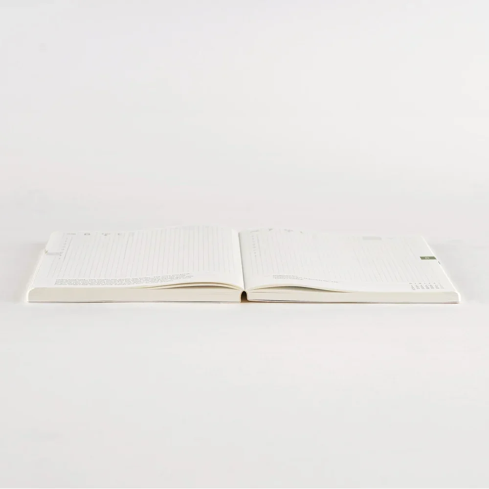 Hobonichi Techo Cousin A5 2026 open flat to show the thread-stitched lay-flat binding in profile