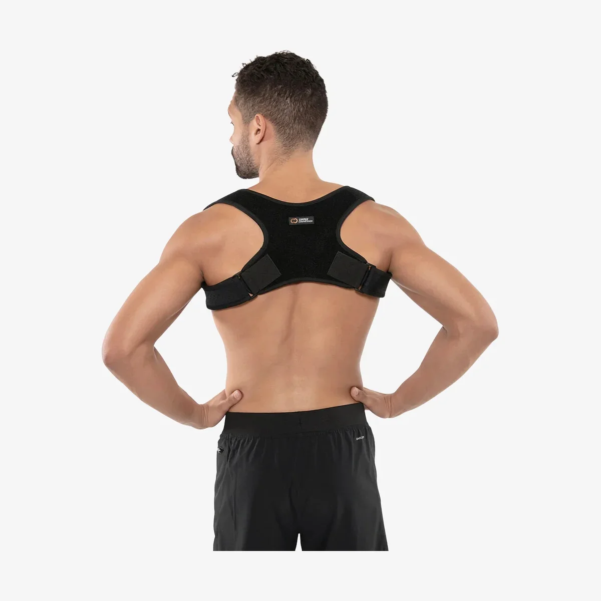 Copper Compression Posture Corrector worn from behind showing the copper-infused fabric back brace and shoulder straps