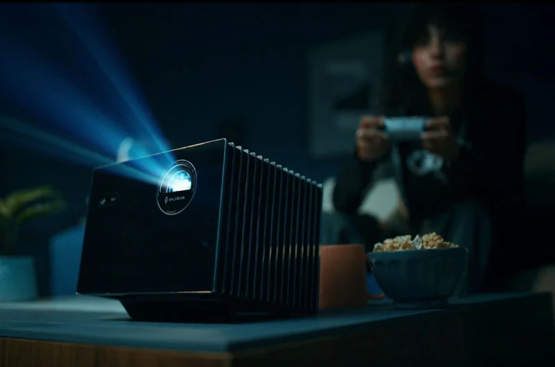 Valerion VisionMaster Pro 2 projecting in a living room while someone games with a controller
