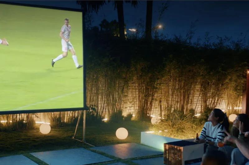 Valerion VisionMaster Pro 2 projecting on an outdoor screen at night for a group