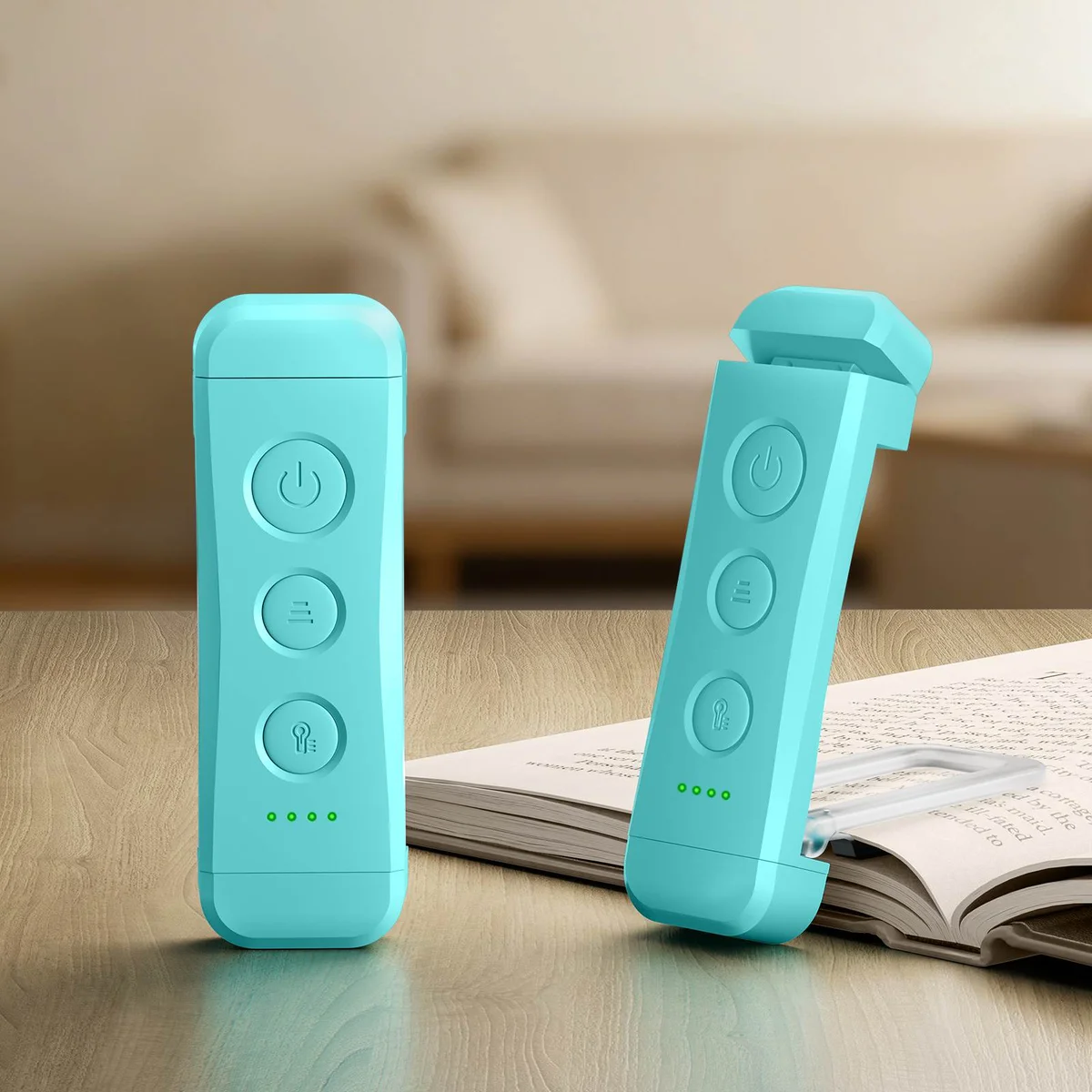 Two Blue Glocusent Bookmark Style Reading Lights on a wooden table, one clipped onto an open book by its clear bookmark clip