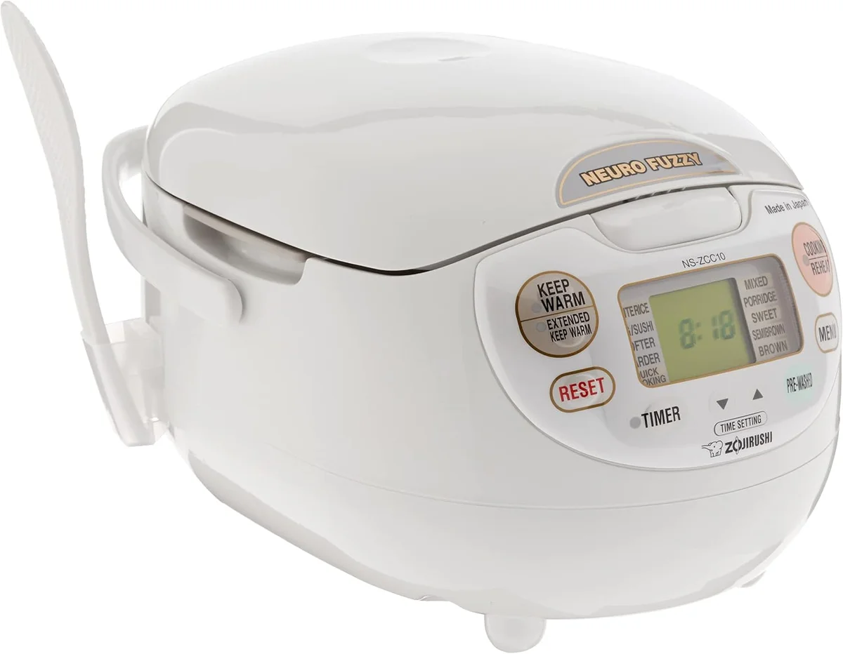 Zojirushi NS-ZCC10 Neuro Fuzzy rice cooker three-quarter view showing LCD control panel and flip-up lid