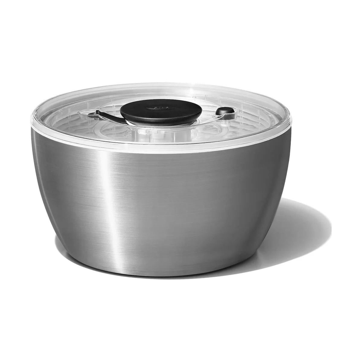 OXO Steel Salad Spinner front three-quarter view showing the brushed stainless steel bowl, clear lid, black pump knob and brake button