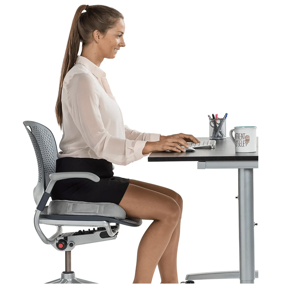 Woman sitting at office desk using ComfiLife Gel Enhanced Seat Cushion