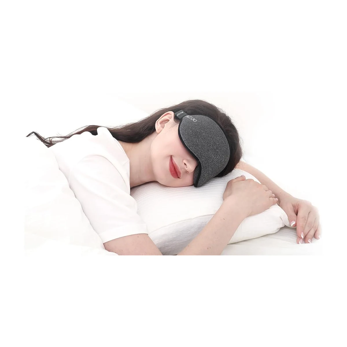 Woman side-sleeping on a pillow while wearing the MZOO 3D Contoured Sleep Mask, showing the low-profile in-use fit
