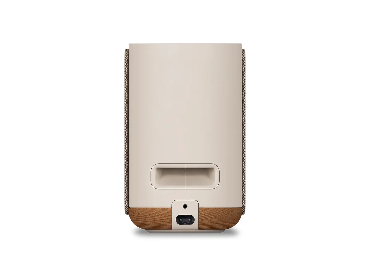 Bose Lifestyle Ultra Smart Speaker rear view showing 3.5mm aux input and power connector on wood base