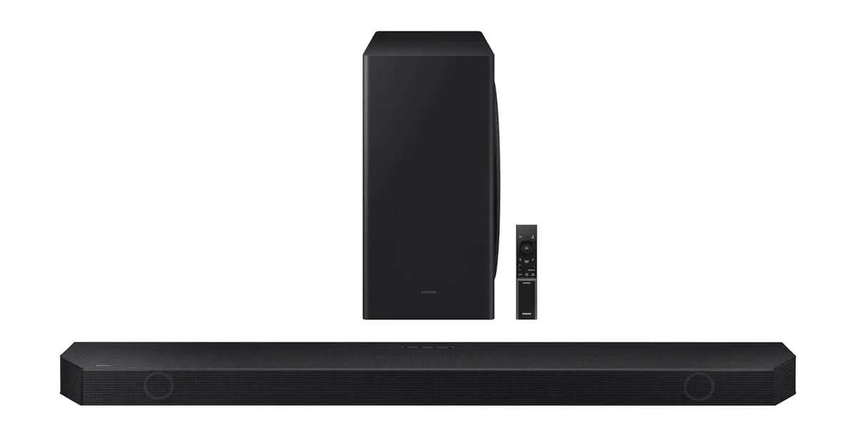 Samsung HW-Q990F soundbar with subwoofer prominently displayed behind and remote control alongside