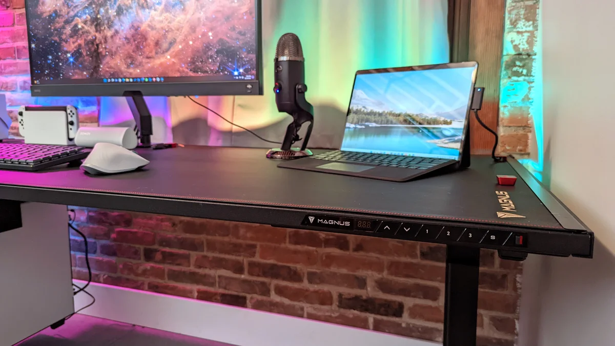 SecretLab Magnus Pro front edge showing MAGNUS keypad and desk surface
