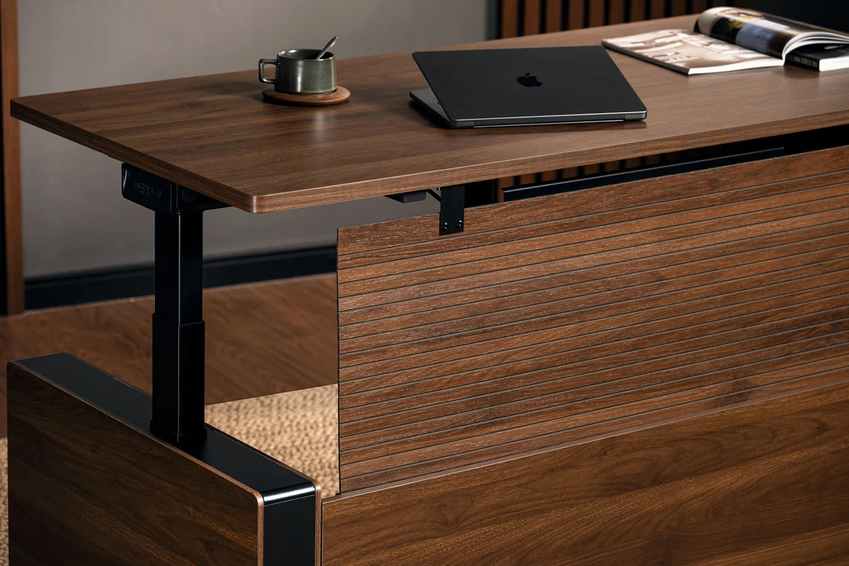 Vernal Standing Desk close-up showing walnut wood grain, laptop, and build detail