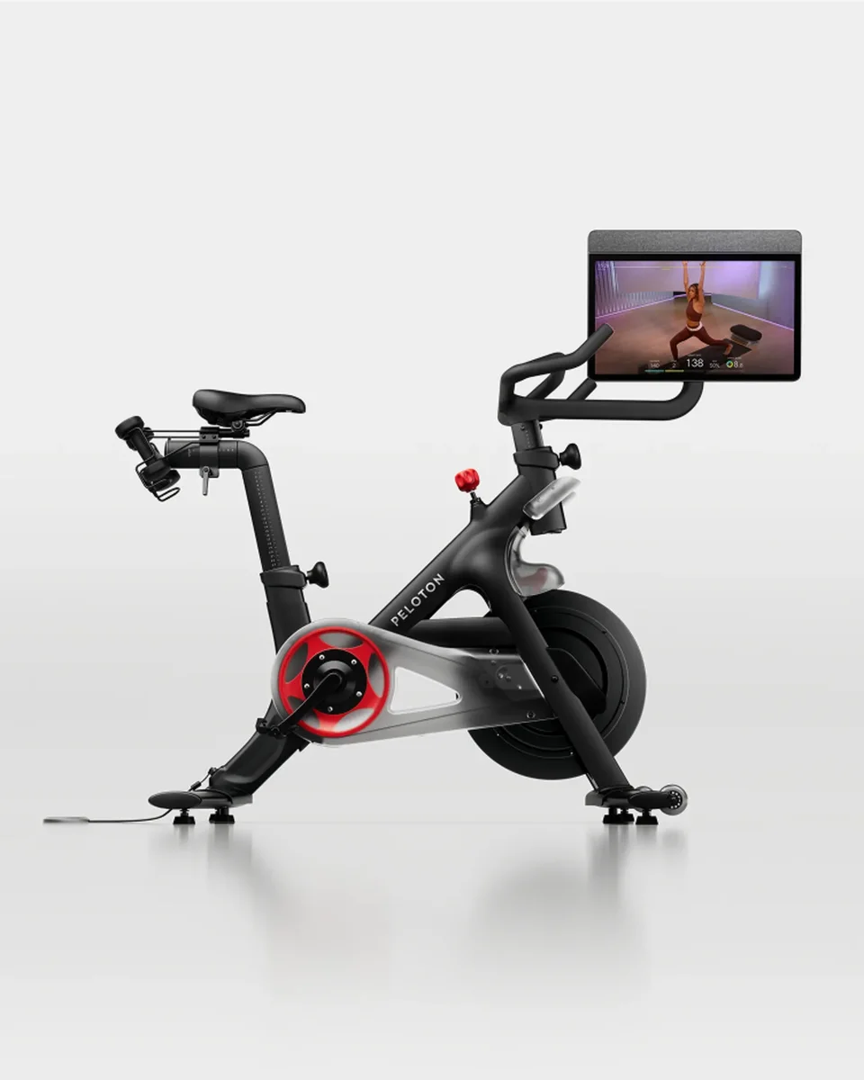 Peloton Bike 3/4 front view with 21.5-inch touchscreen showing live class