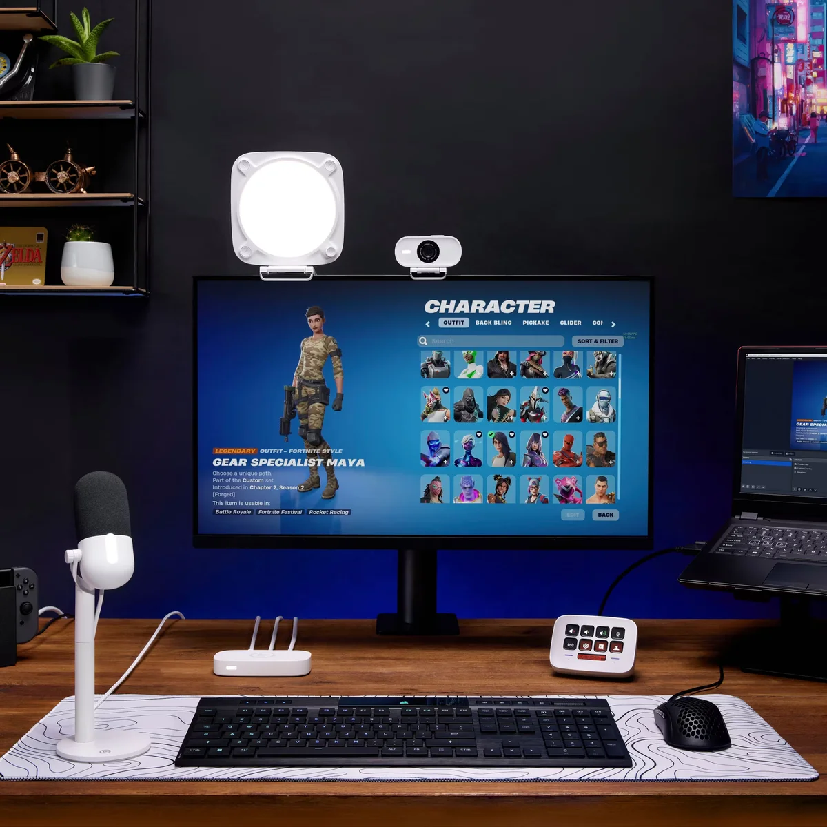 Elgato Stream Deck Neo on a gaming desk setup with monitor, key light, and microphone