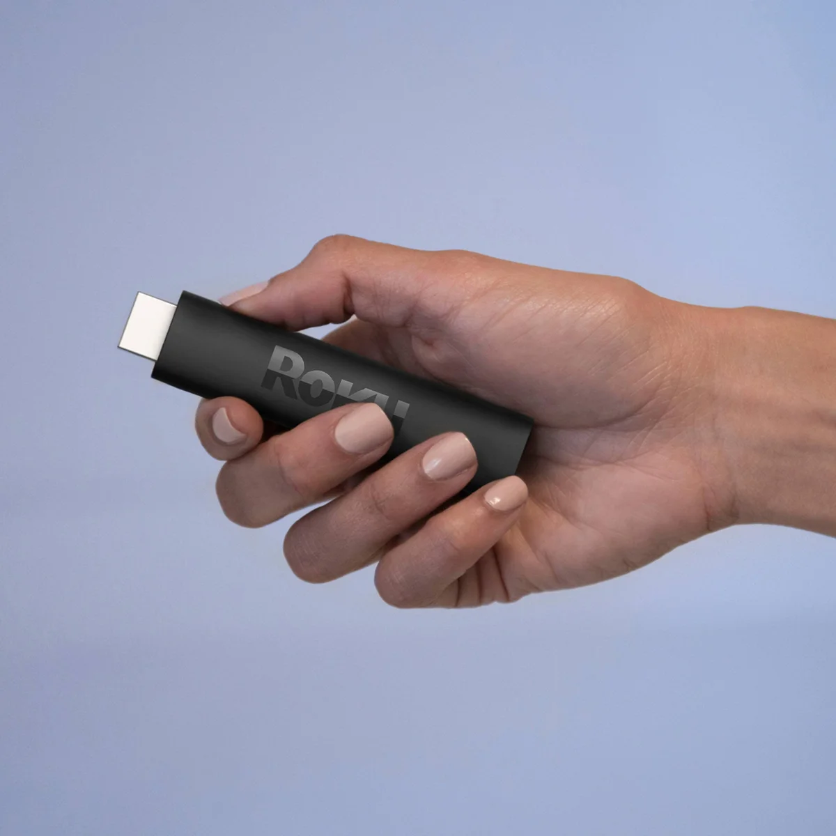 Roku Streaming Stick 4K held in hand showing compact form factor