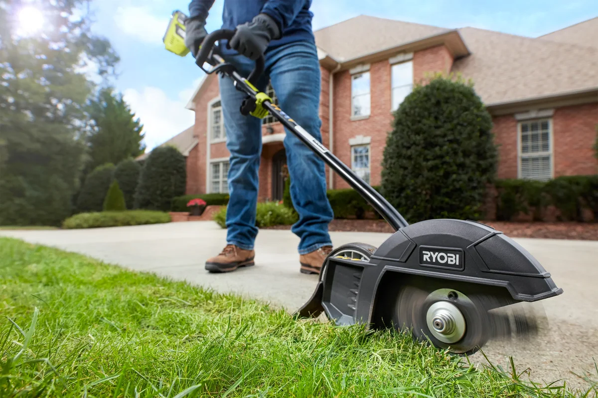 Close-up of Ryobi 40V string trimmer cutting head spinning at lawn edge