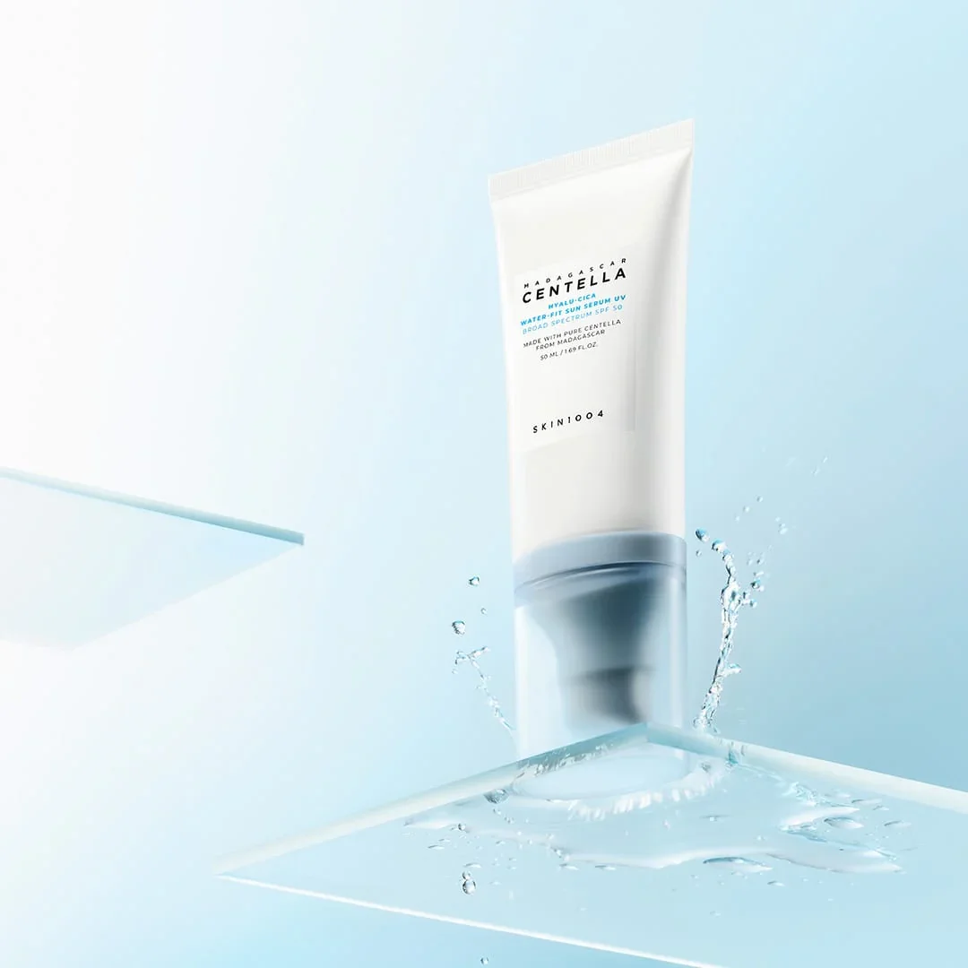 Skin1004 Sun Serum tube with water splash on glass surface