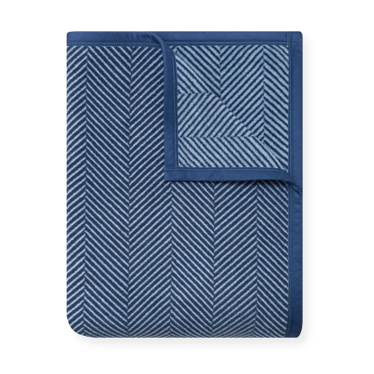 ChappyWrap Harborview Herringbone blanket folded, showing navy and light-blue herringbone weave with solid navy border