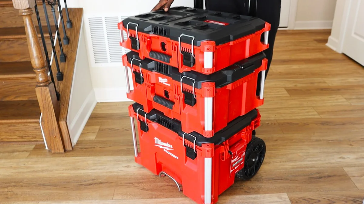 Milwaukee Packout Rolling Tool Box being carried with stacked modules in a home interior