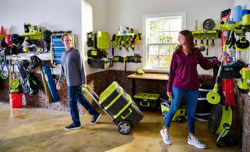 Couple rolling the Ryobi Link Tool Box through an organized garage workshop