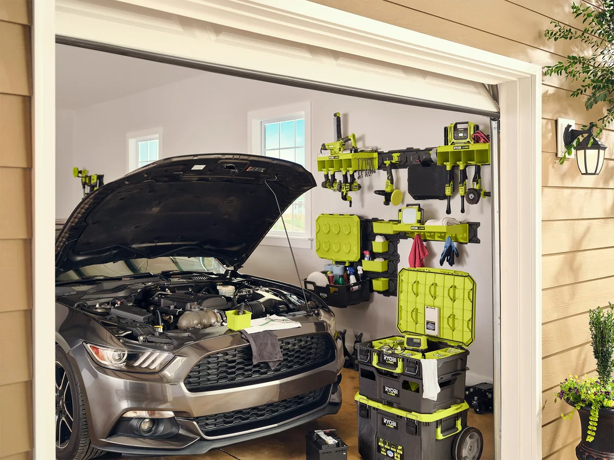 Ryobi Link modular system stacked in a home garage with car and wall-mounted tool storage