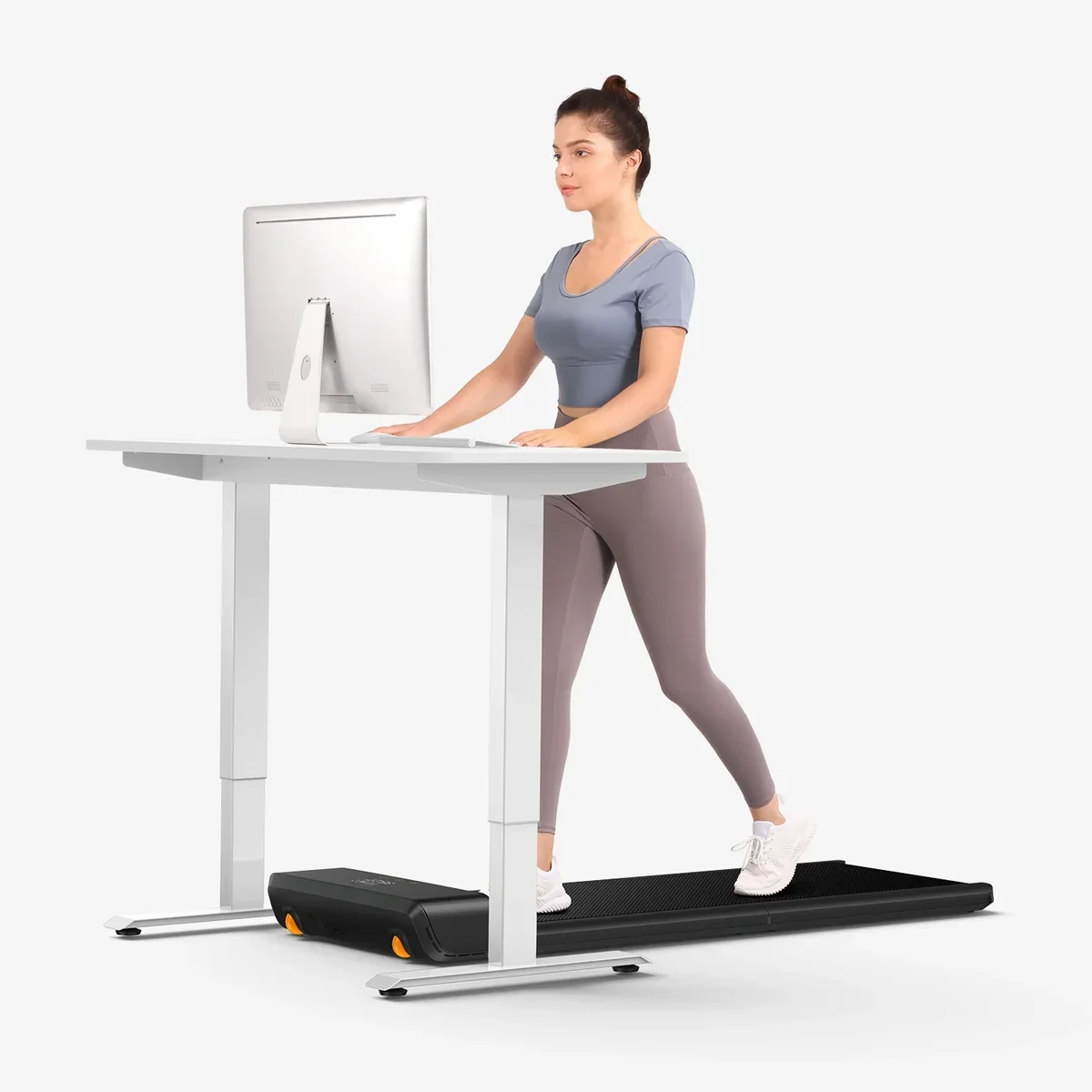 WalkingPad A1 Pro in use under a standing desk with person walking while working