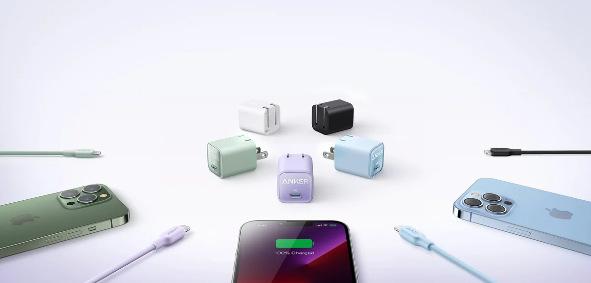 Anker Nano 3 30W chargers in all five colors arranged on a desk with phones and charging cables