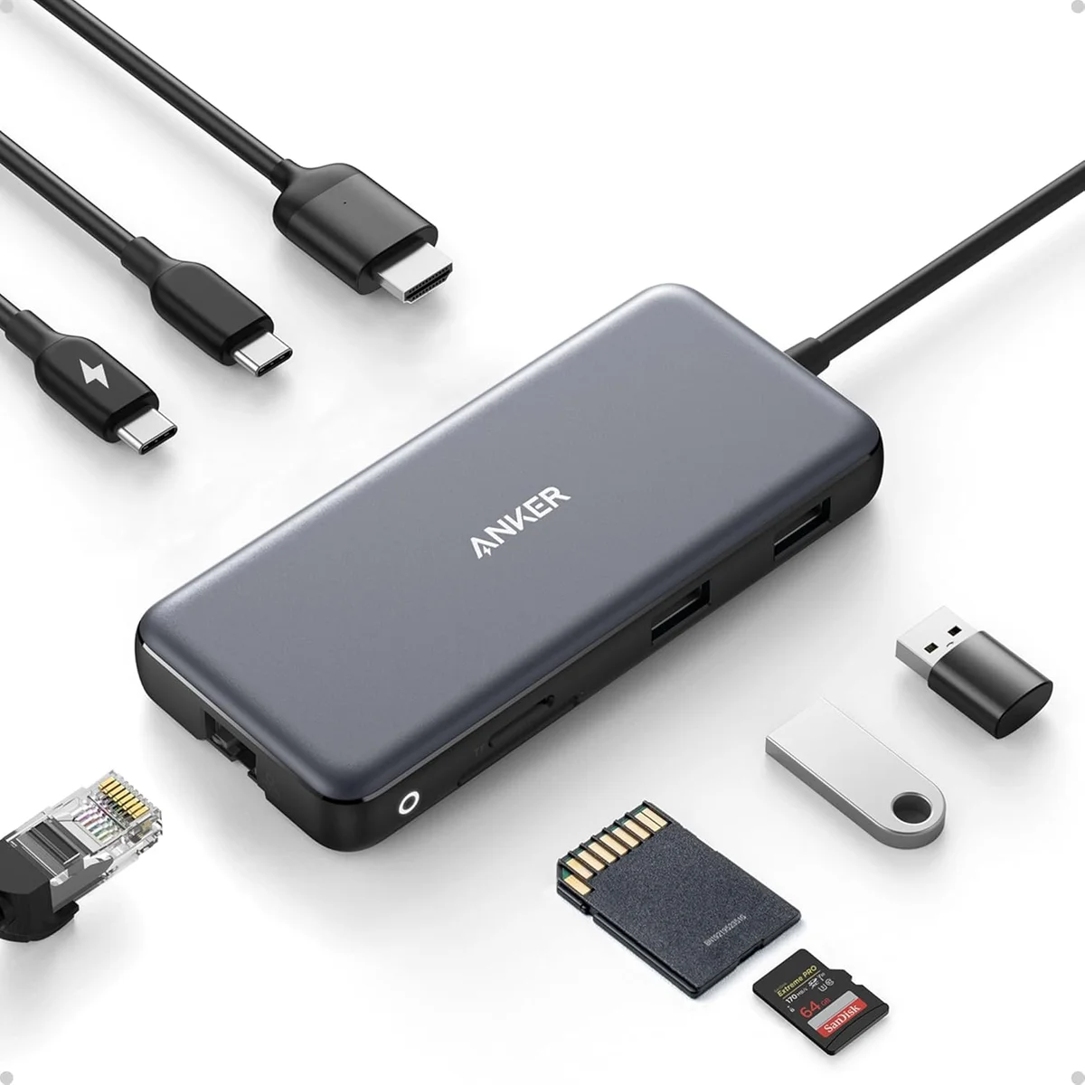 Anker 555 USB-C Hub (8-in-1) laid out with its full port set in use: Ethernet cable, HDMI cable, USB-C cable, two USB-A devices, an SD card, and a microSD card