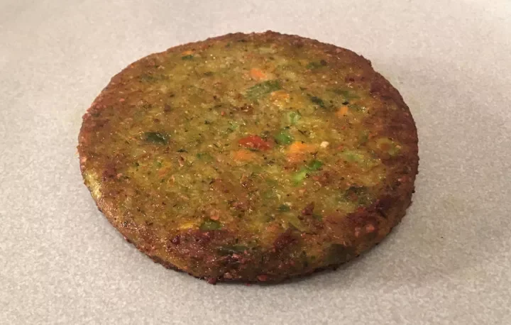 Dr. Praeger's California Veggie Burger cooked patty closeup showing visible vegetables