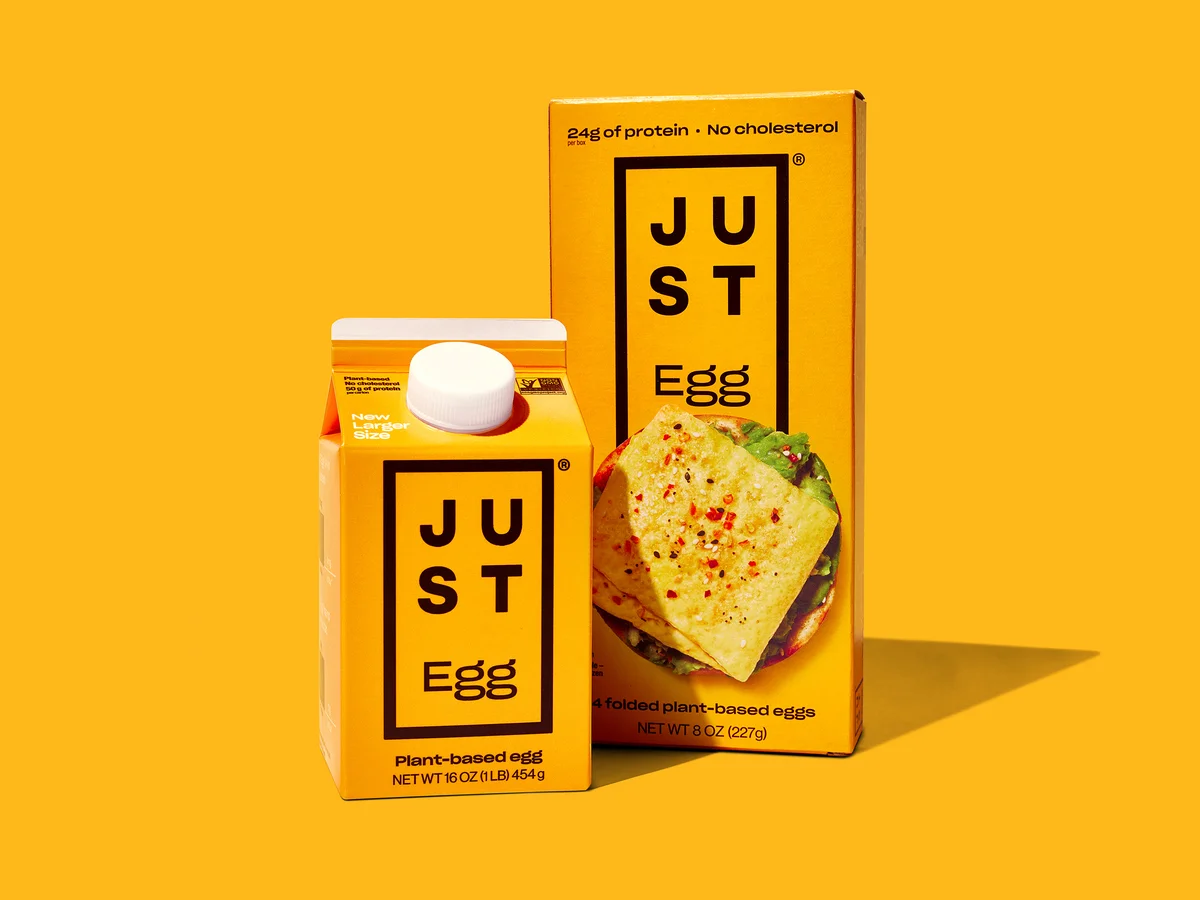 JUST Egg carton and folded egg box product lineup on yellow background