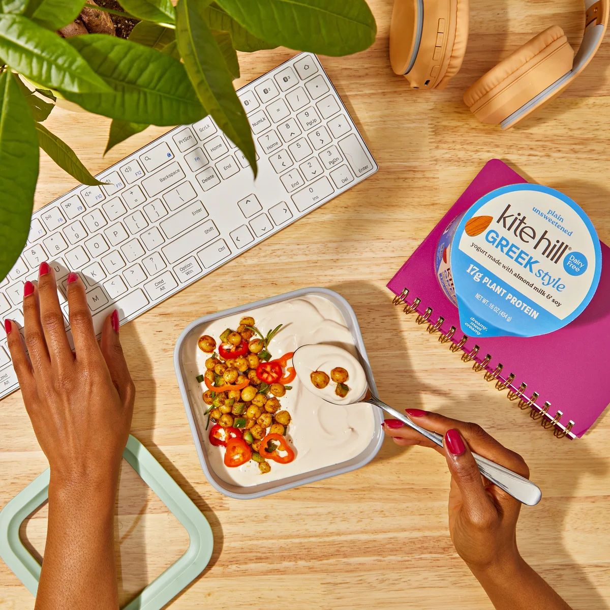 Kite Hill Greek-Style yogurt on a desk with a savory chickpea bowl