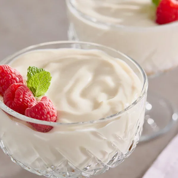 Creamy Silk plain soymilk yogurt served in glass cups with fresh raspberries