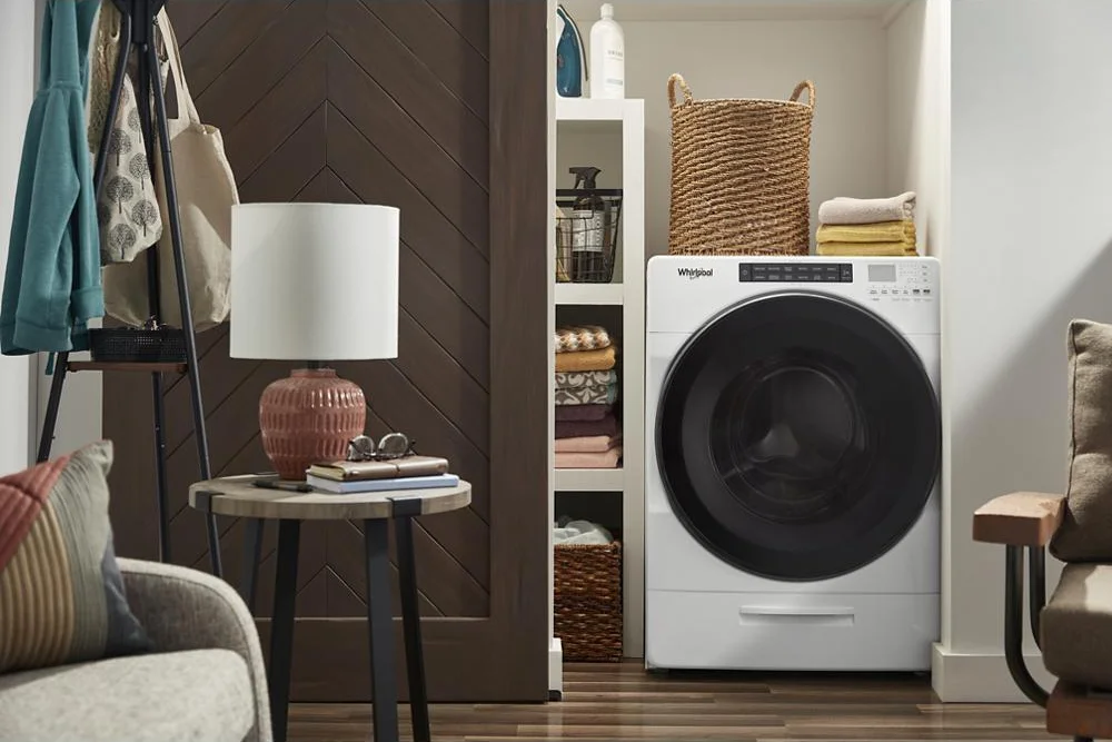Whirlpool All-in-One washer-dryer in a living space laundry closet lifestyle setting