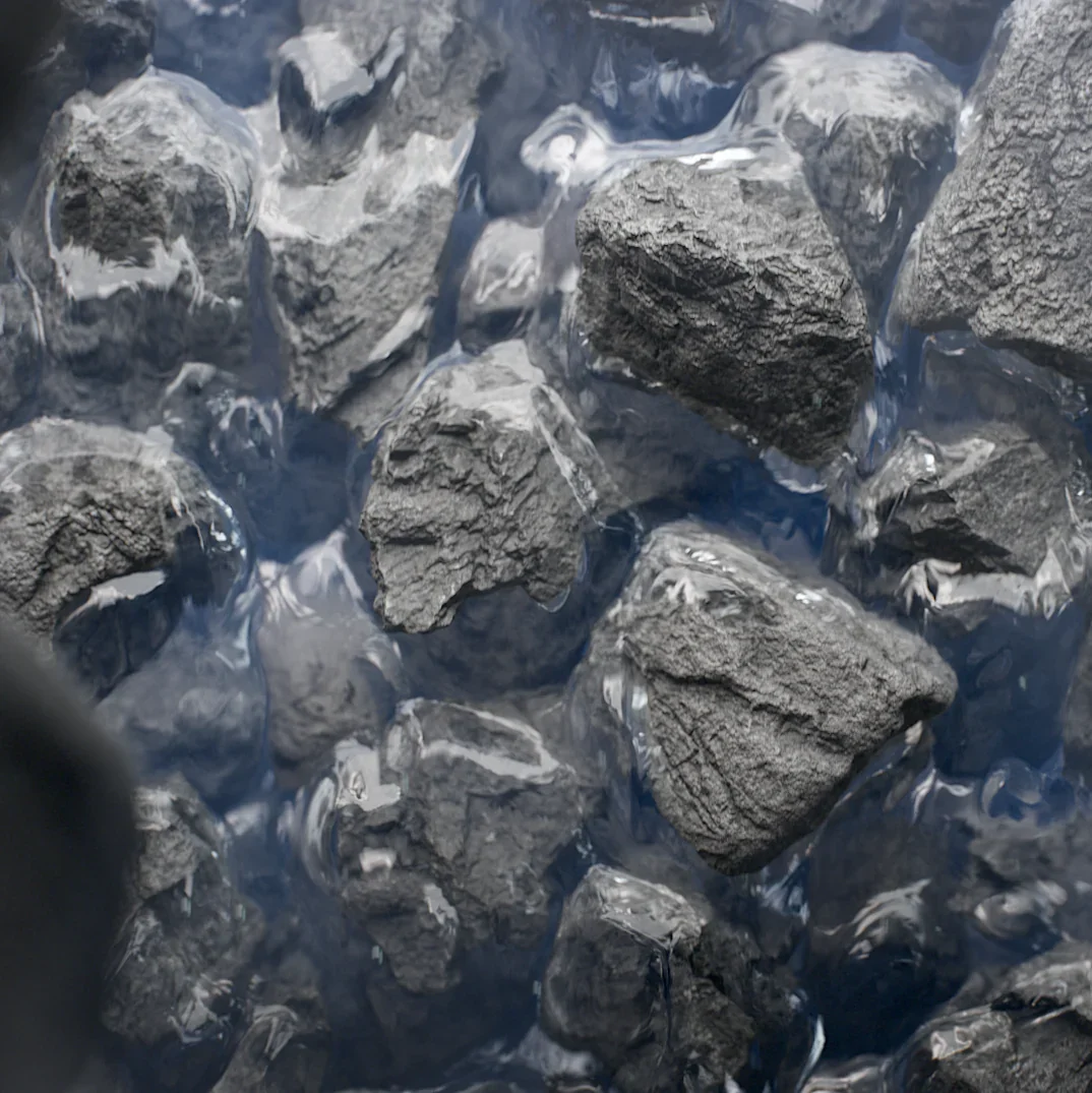 Close-up of activated carbon filter media granules in water inside the Clearly Filtered pitcher