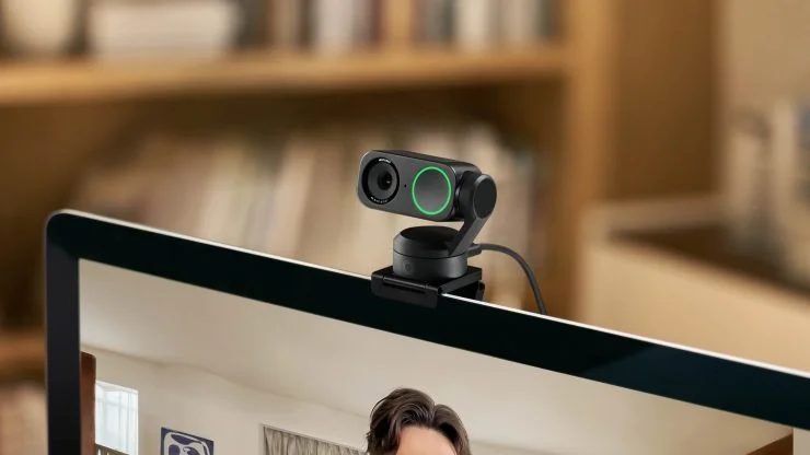 Insta360 Link 2 close-up mounted on top of a monitor showing gimbal mechanism